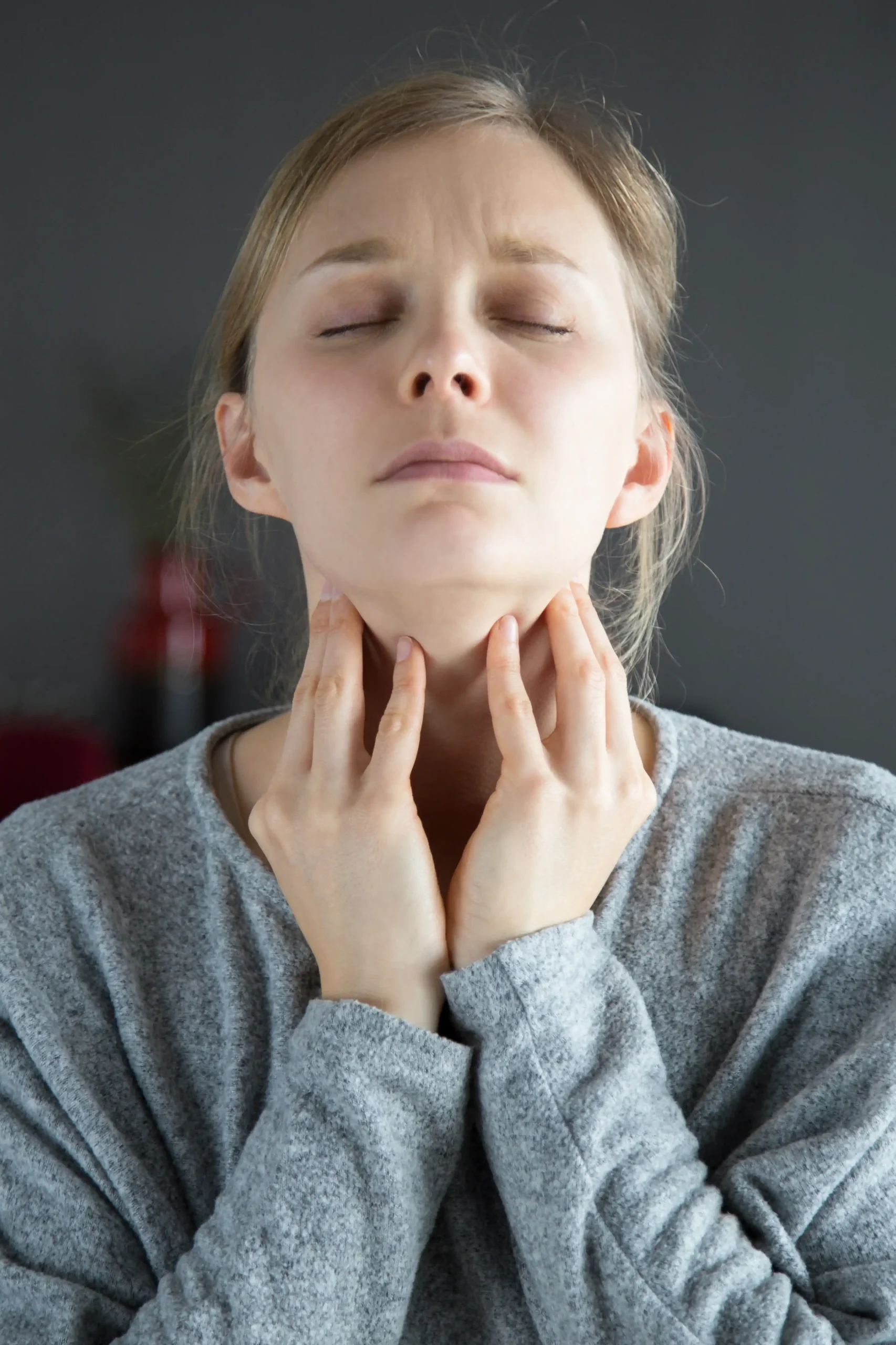 sick woman with closed eyes having sore throat touching neck 11zon